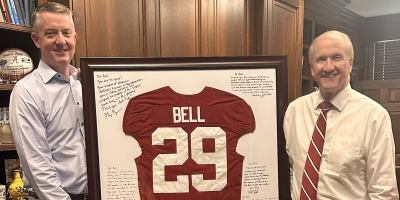 Greg Byrne presents Dr. Stuart Bell with custom Crimson Tide jersey ahead of retirement